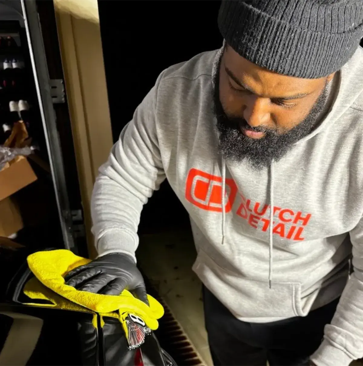 Dennis Hutchins of Clutch Detail Atlanta hand-detailing a vehicle